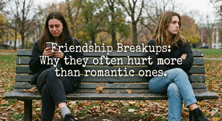 Two young women sitting apart on a park bench in autumn; one is crying while looking at her phone, and the other is looking away with crossed arms. Text overlaid on the center reads: "Friendship Breakups: Why they often hurt more than romantic ones."
