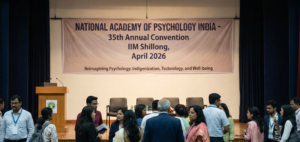 Banner and stage setup for the National Academy of Psychology India 35th Annual Convention at IIM Shillong, April 2026.