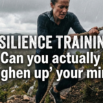 A woman with a determined expression climbs a steep, rocky mountain face using a rope in the rain. Overlaid text reads "RESILIENCE TRAINING: Can you actually 'toughen up' your mind?".